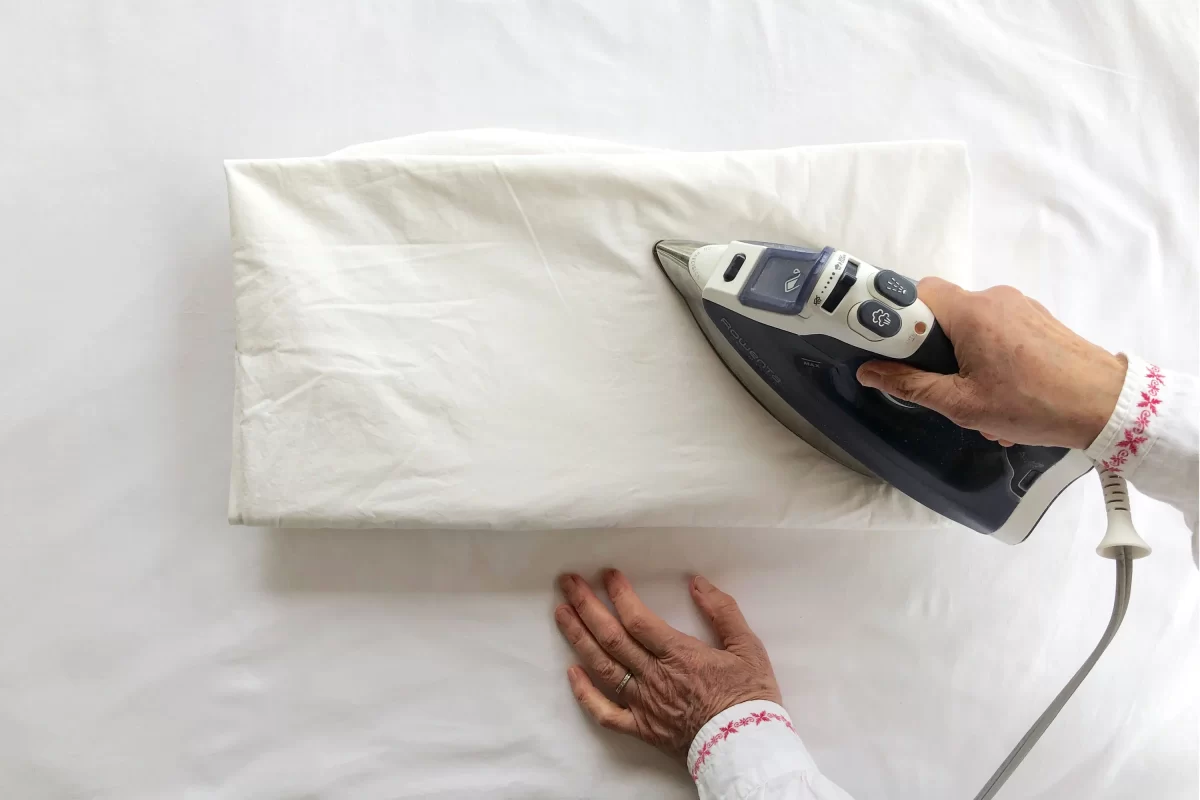 Ironing sheets on the bed